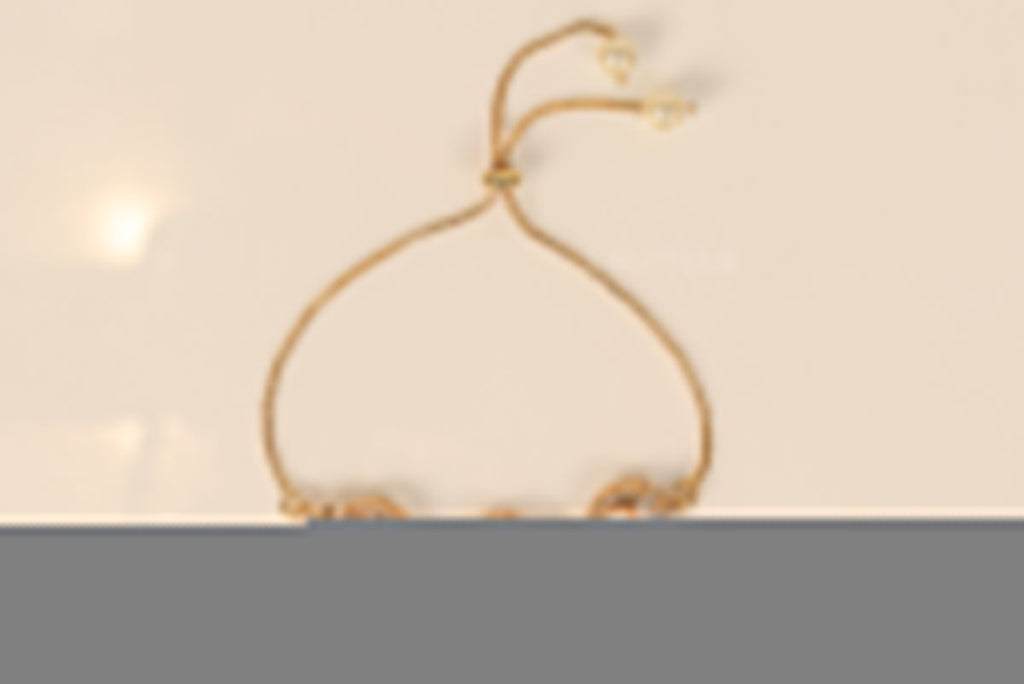 Gold plated sling bracelet with snake motifs