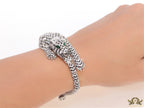 Cubic zirconia stone studded panther motif with emerald green colour stone details platinum plated bracelet