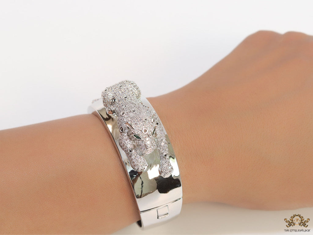 Broad band platinum bracelet with cz panther motif