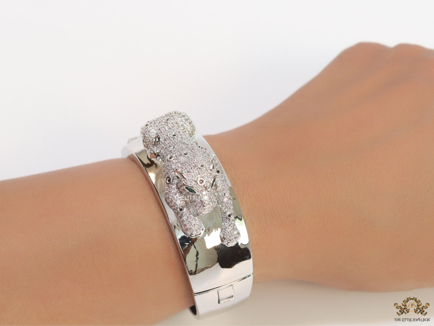 Broad band platinum bracelet with cz panther motif