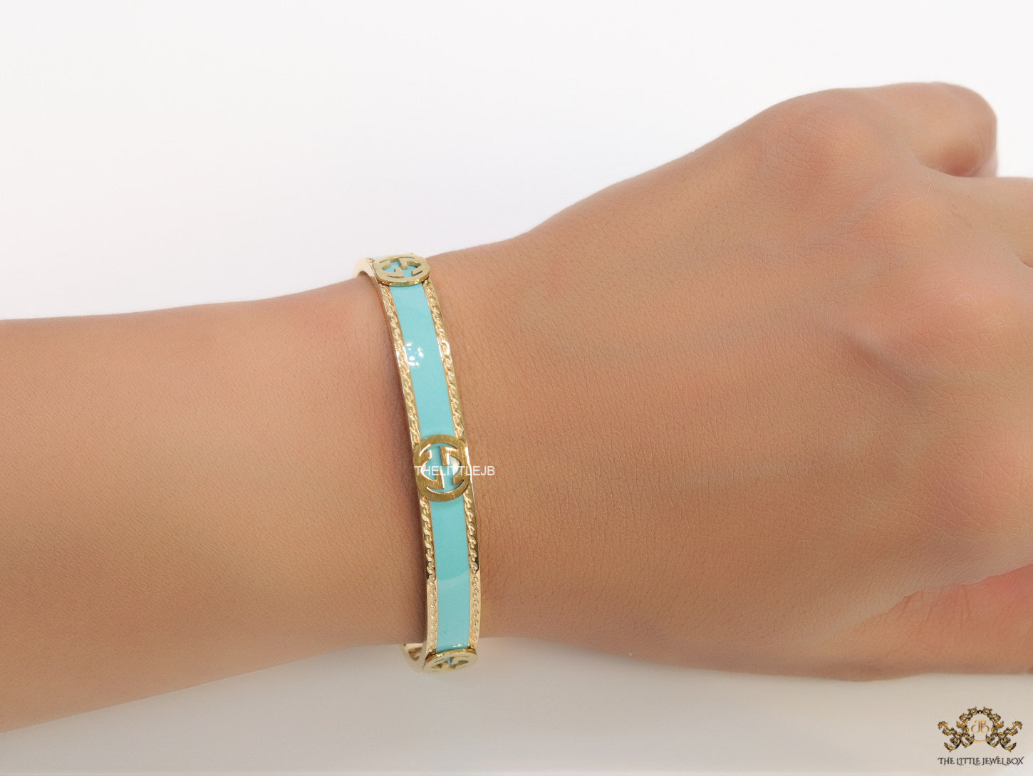 Blue and golden open band bracelet with twin G alphabet motifs