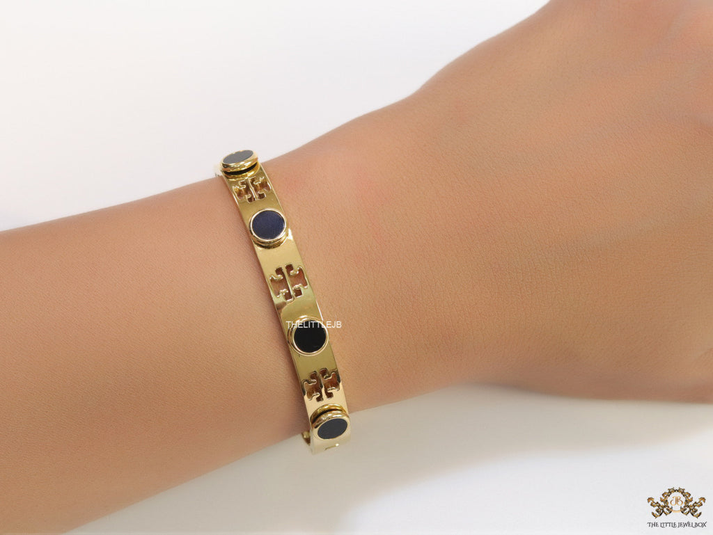 Gold plated cutwork twin T motif bracelet with black stones
