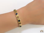 Gold plated cutwork twin T motif bracelet with black stones