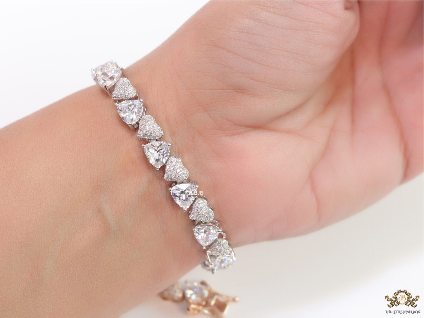 Fancy cut triangle and heart shape cz bracelet in platinum finish