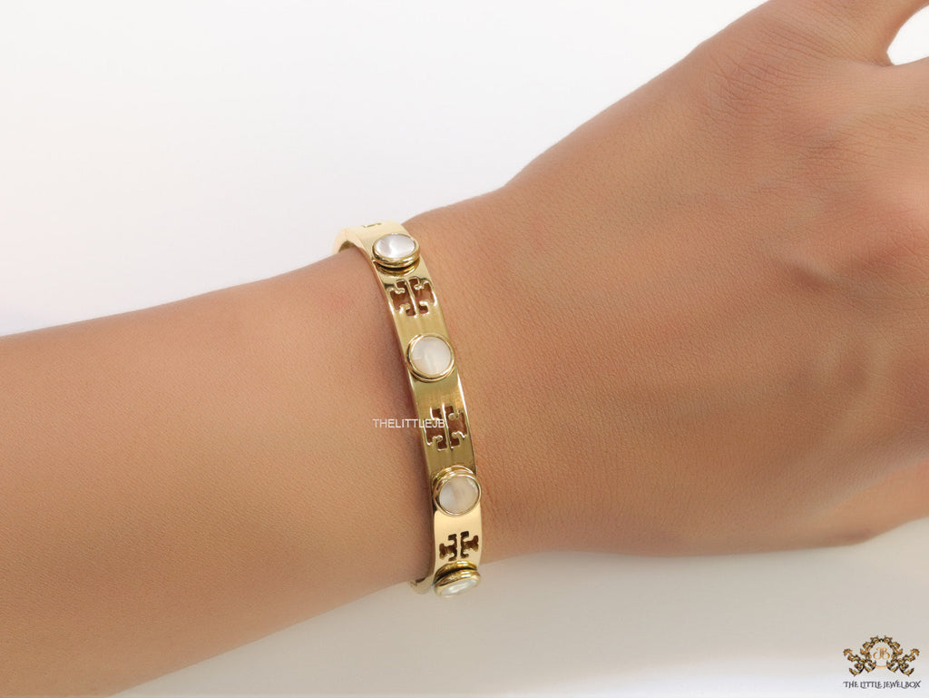 Gold plated cutwork twin T motif bracelet with white stones