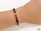 Sleek maroon and golden bracelet with C alphabet in centre
