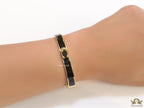 Sleek black and golden bracelet with C alphabet in centre