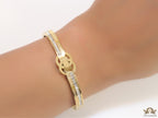 Gold plated bracelet with cz, inscribed alphabets and twin disc motif