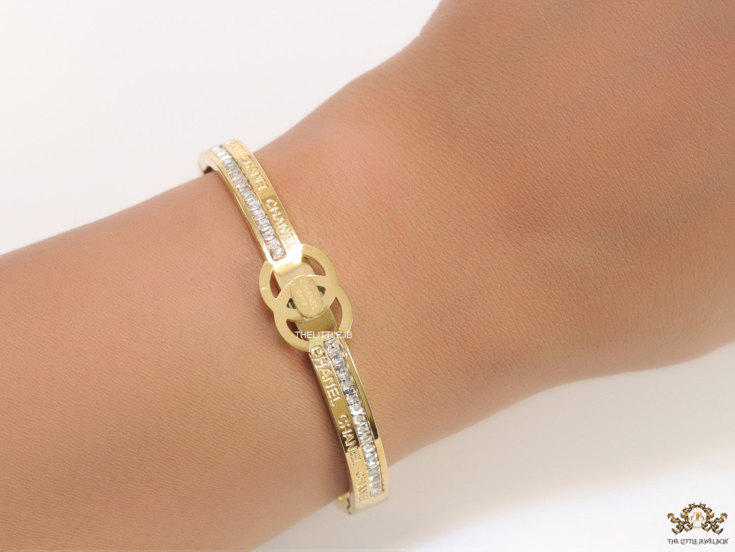 Gold plated bracelet with cz, inscribed alphabets and twin disc motif