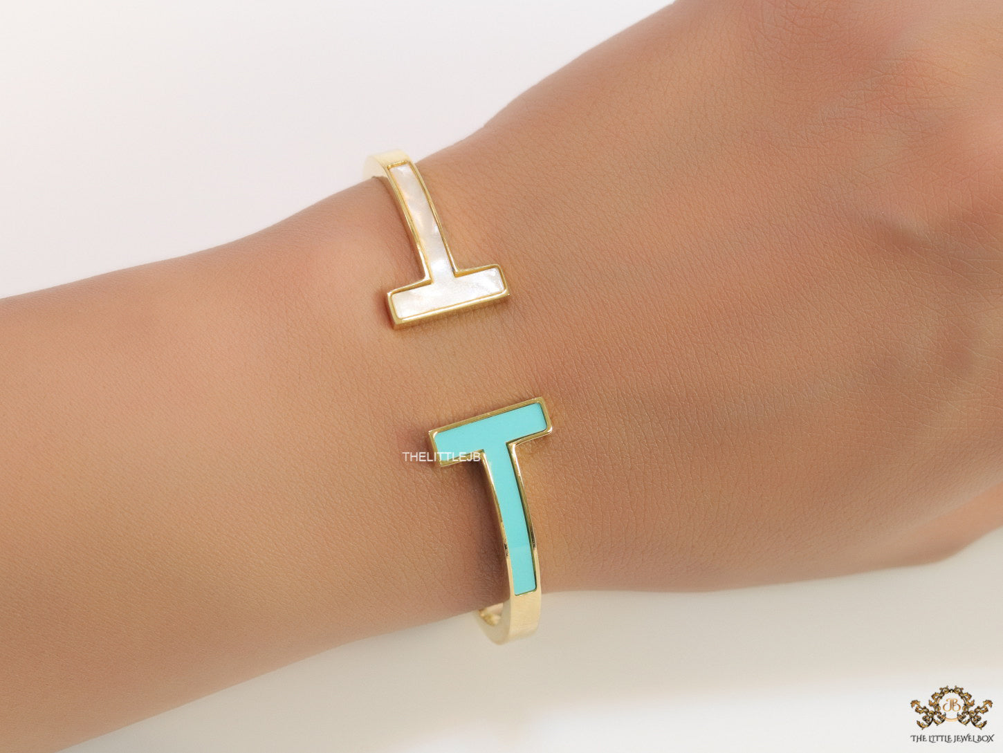Gold plated open bracelet with blue enamel and MOP ends