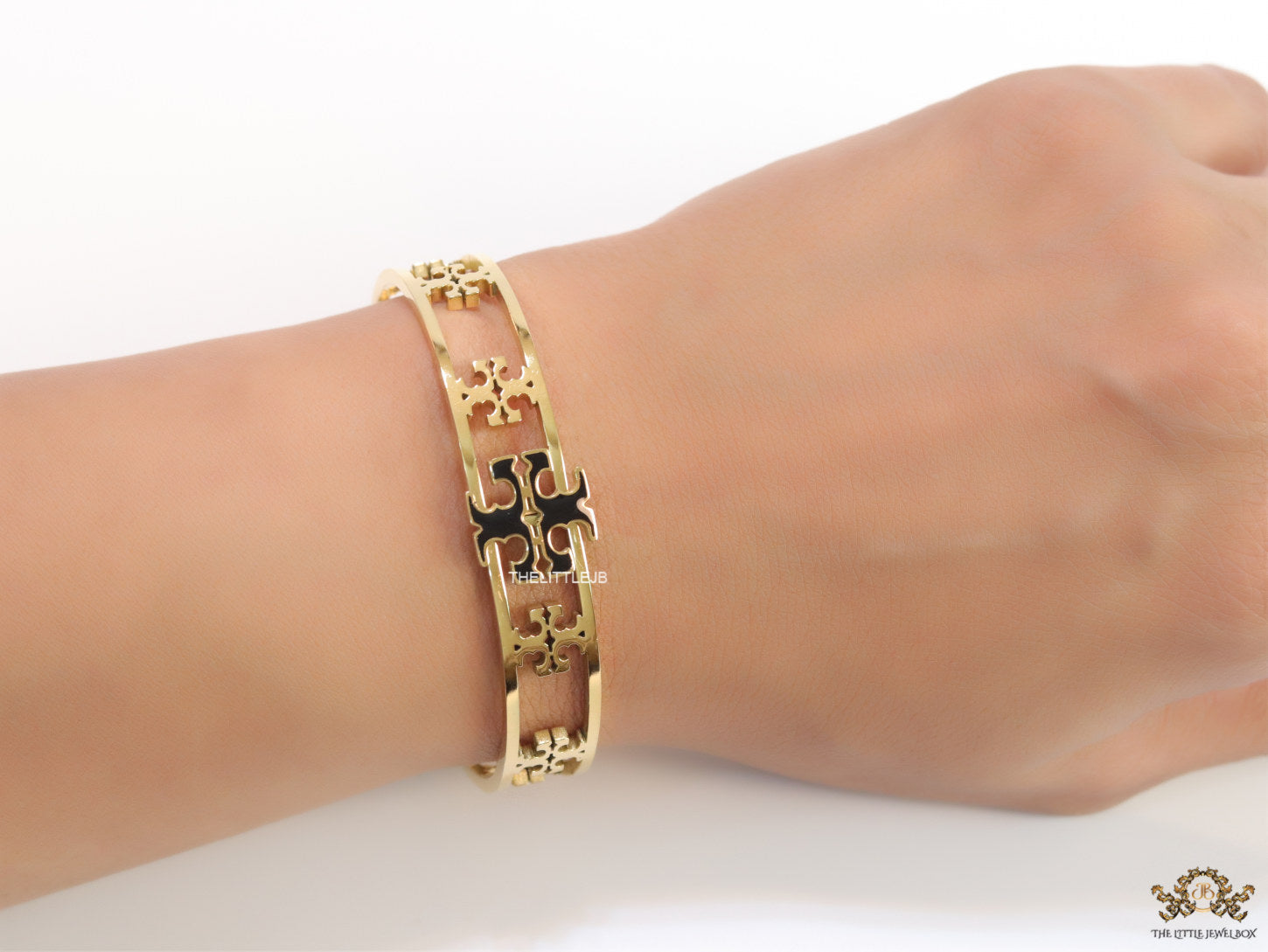 Gold plated openable bracelet with fancy cutwork T motifs