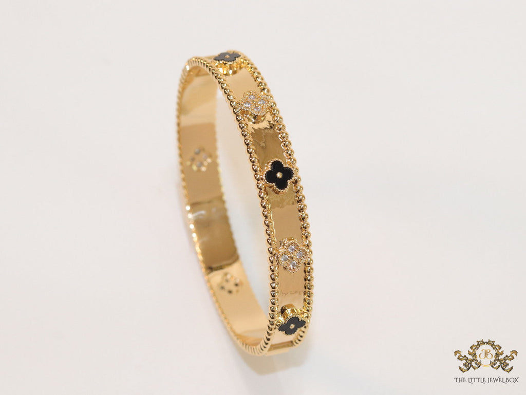 Gold plated bracelet with clover motifs in cz and black enamel
