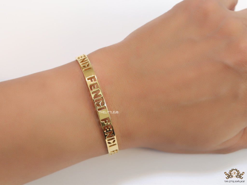 Gold plated open band bracelet with cutwork alphabets