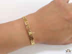 Gold plated open band bracelet with cutwork alphabets