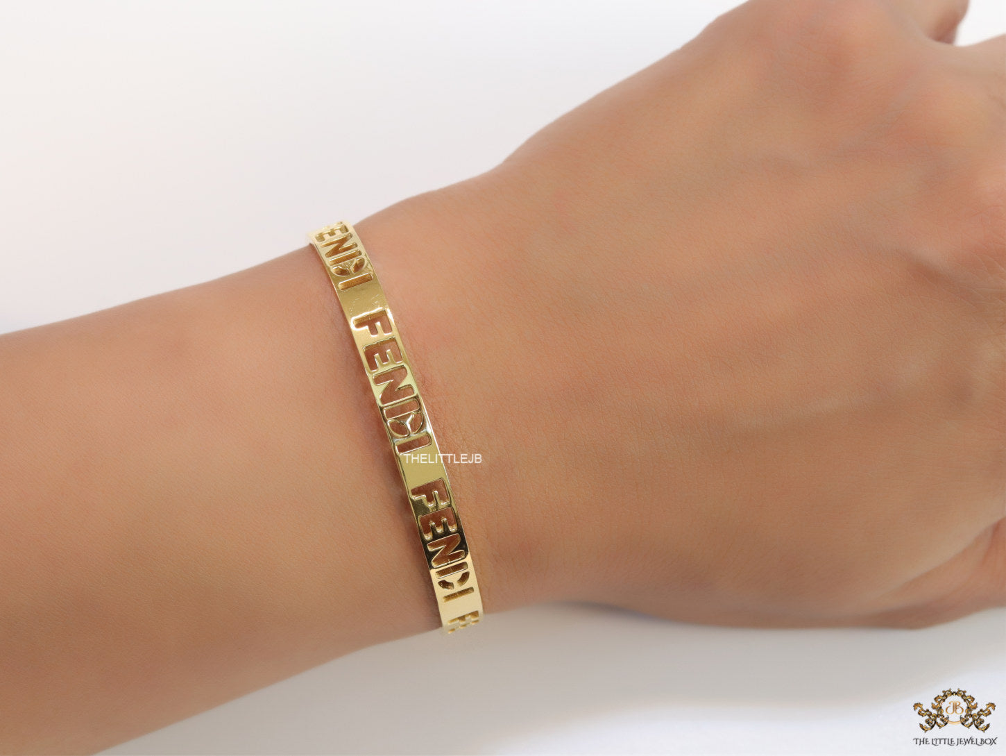 Gold plated open band bracelet with cutwork alphabets