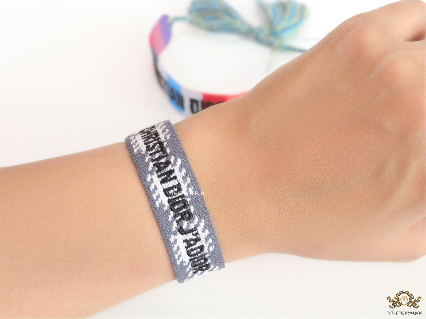 Woven grey bracelet band with black knitted alphabets