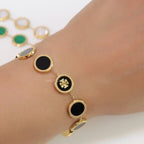 Gold plated chain bracelet with T motif on black enamel coating