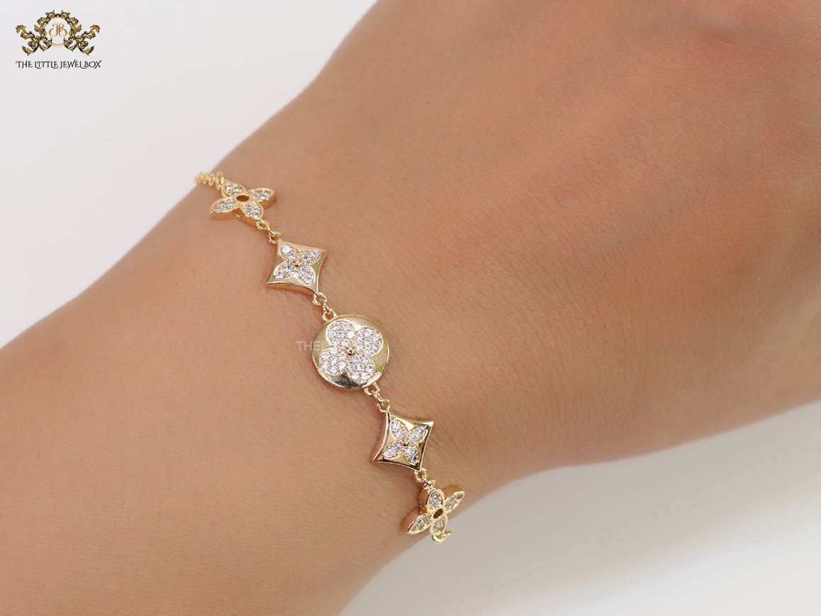 Gold plated chain bracelet with cz clovers and flowers