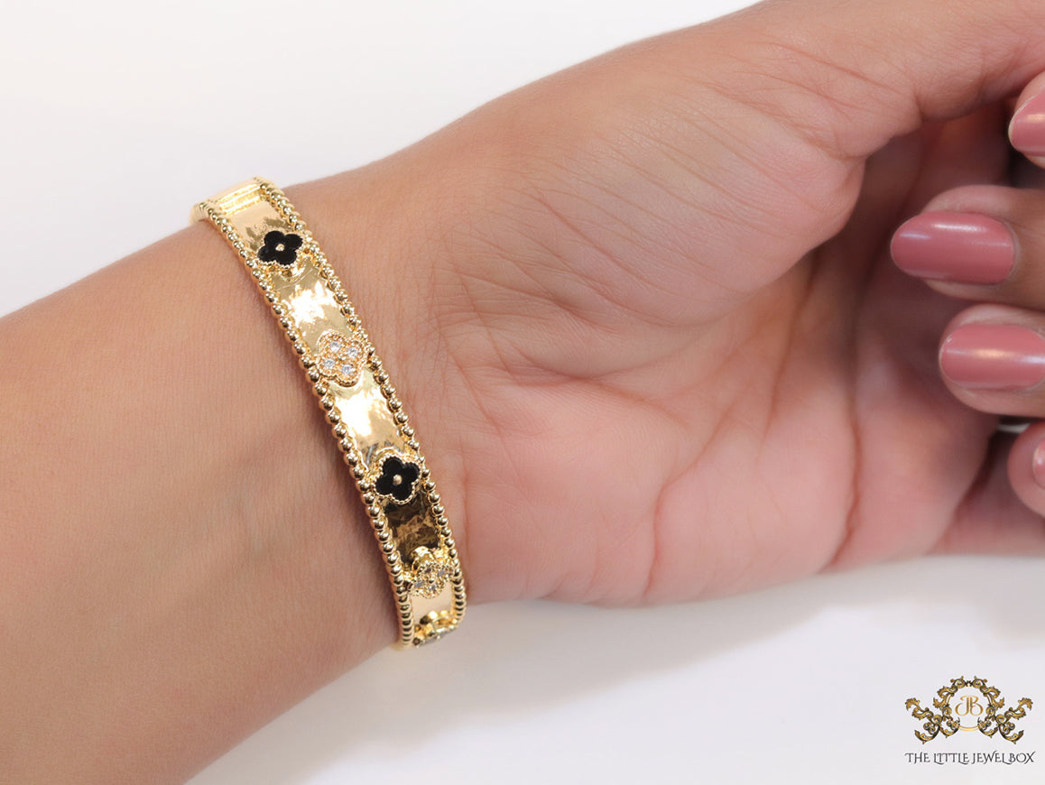 Gold plated bracelet with clover motifs in cz and black enamel
