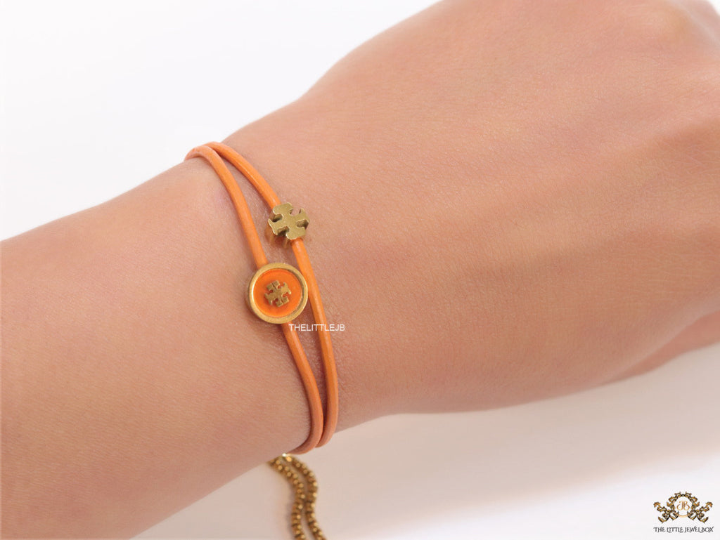 Adjustable double string orange bracelet with twin T motifs