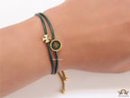 Adjustable double string green bracelet with twin T motifs