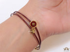 Adjustable double string maroon bracelet with twin T motifs