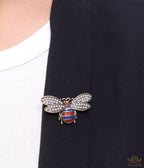 Antique gold finish bee brooch with white and red stones and blue details