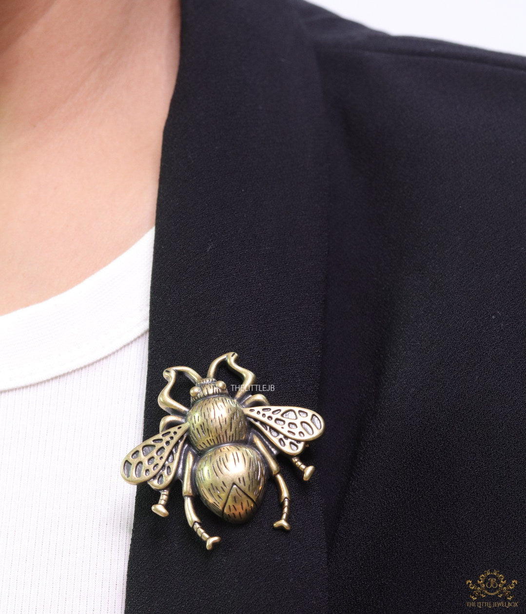 Antique gold finish bee brooch with white and red stones and blue details