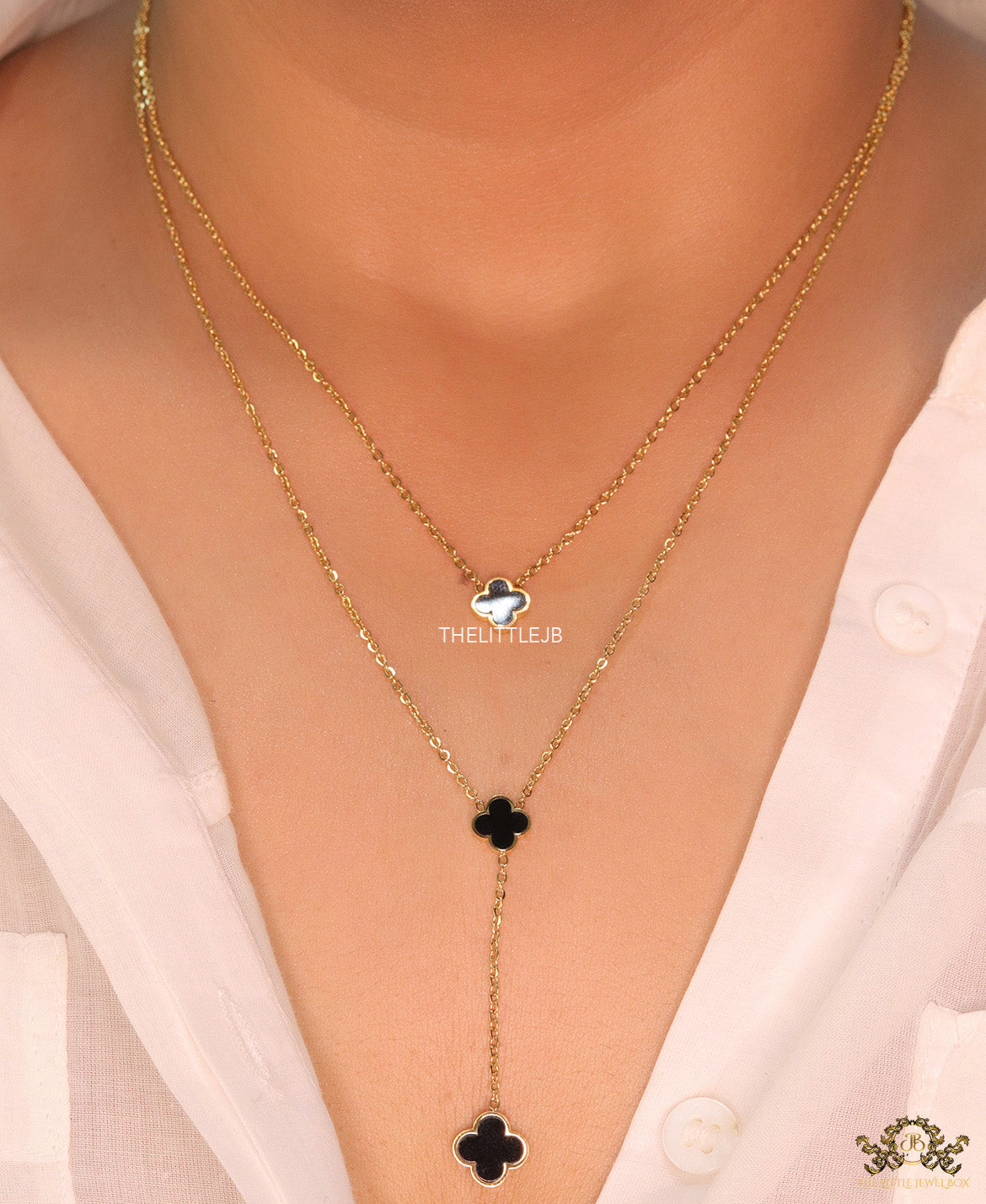 Dual chain necklace with black onyx clovers in gold finish