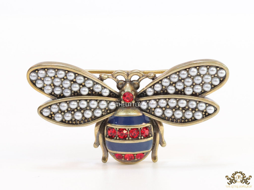 Antique gold finish bee brooch with white and red stones and blue details