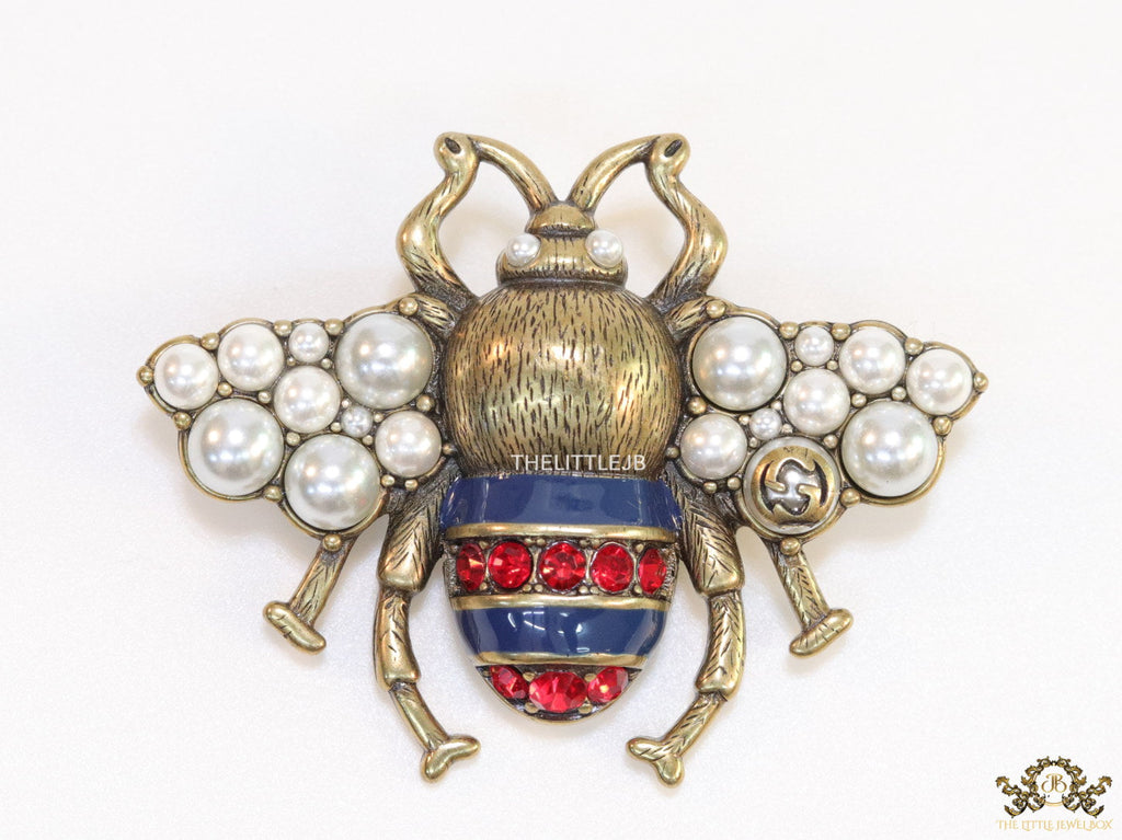 Antique gold finish double G bee brooch with blue details and white and red stones