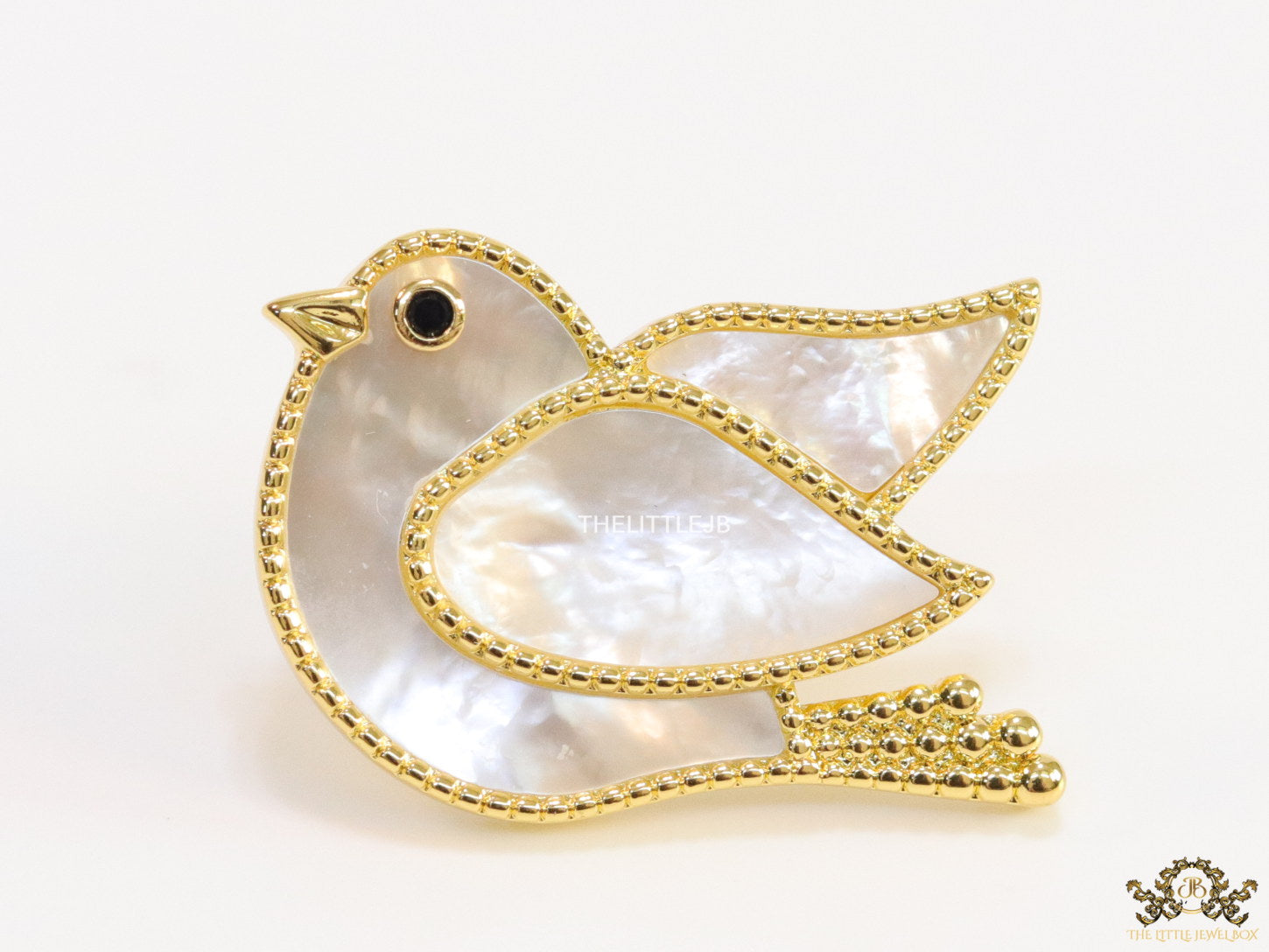 Gold plated white bird brooch
