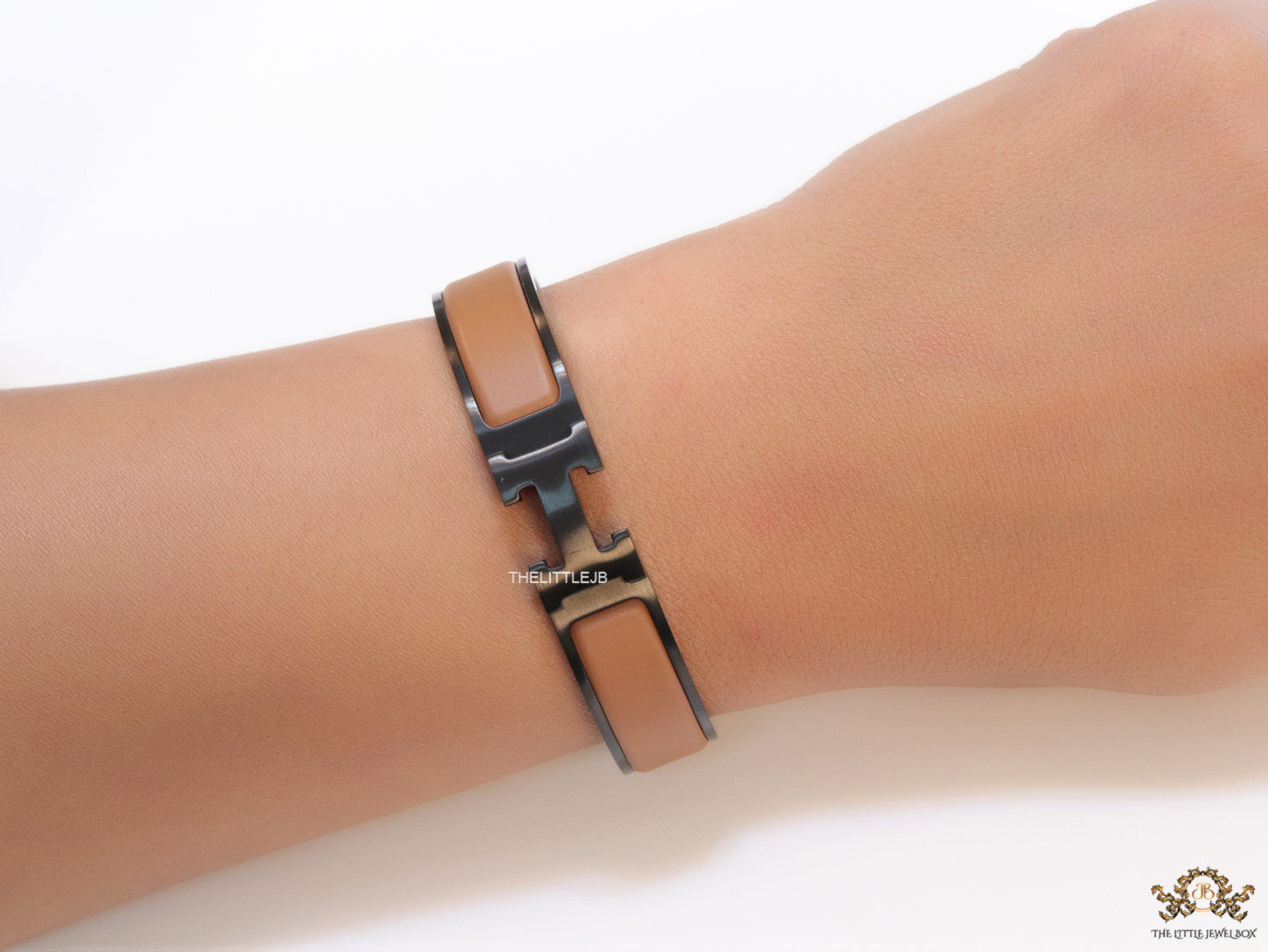Premium collection band style bracelet in matt tan with black metallic details and black T alphabet motif