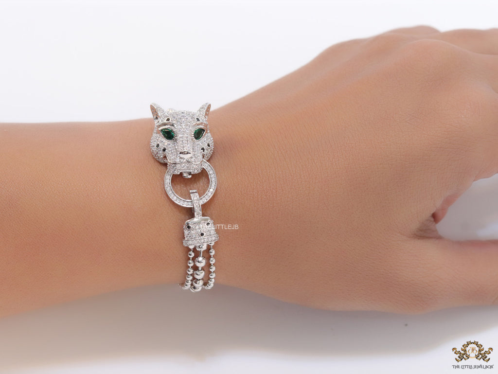 Platinum plated bracelet with cubic zirconia stones panther face motif with green cubic zirconia stone details and cubic zirconia stones disc