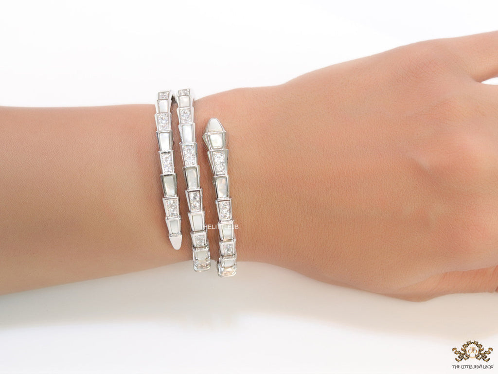 Triple line platinum plated minimal snake bracelet with cubic zirconia stones and pearl white stones.