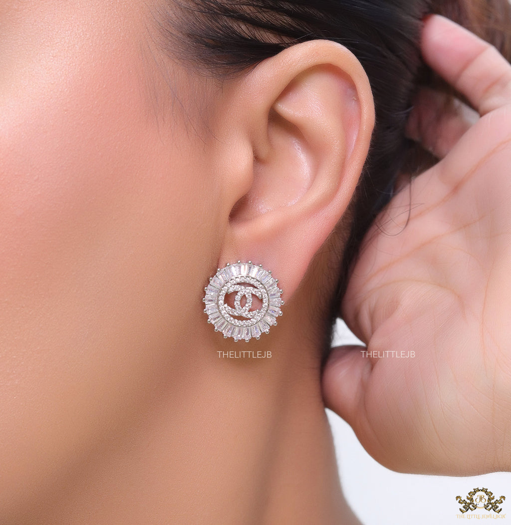 Round platinum studs lined with cz baguettes and twin C cz motif centre