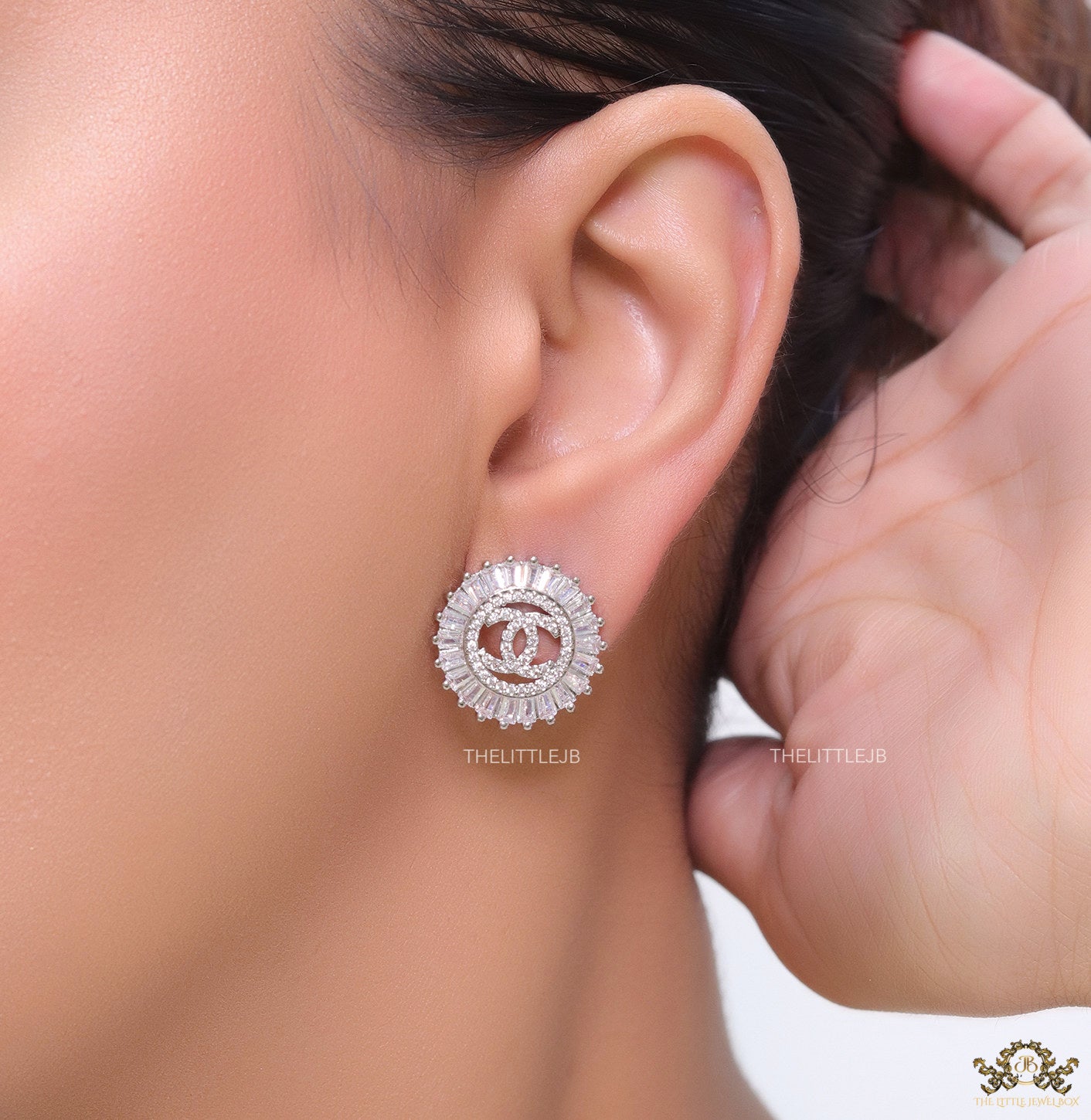 Round platinum studs lined with cz baguettes and twin C cz motif centre
