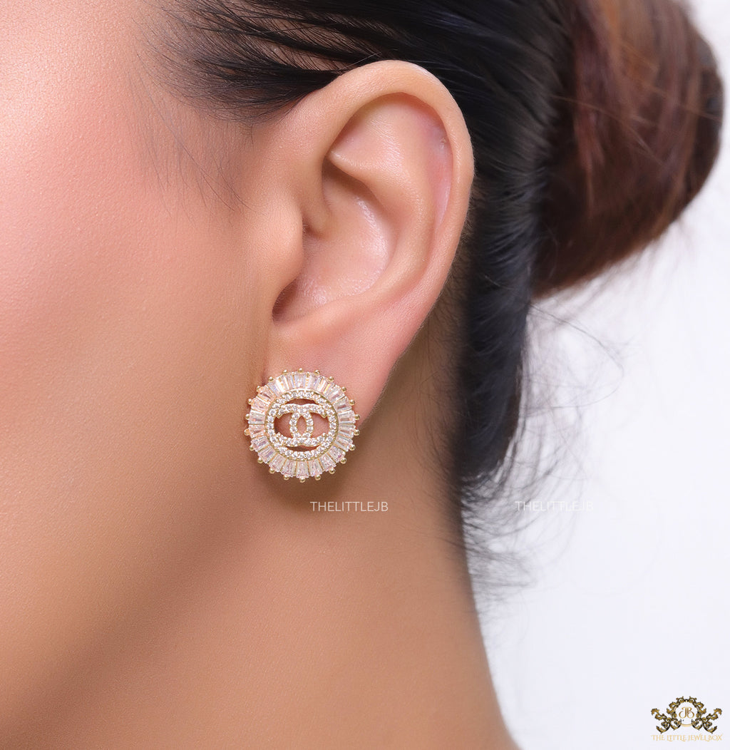 Round gold studs lined with cz baguettes and twin C cz motif centre