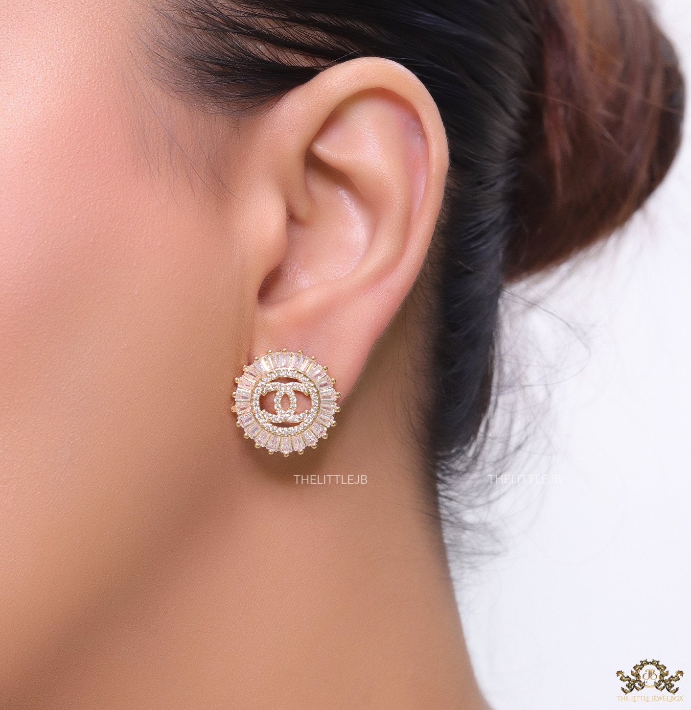 Round gold studs lined with cz baguettes and twin C cz motif centre