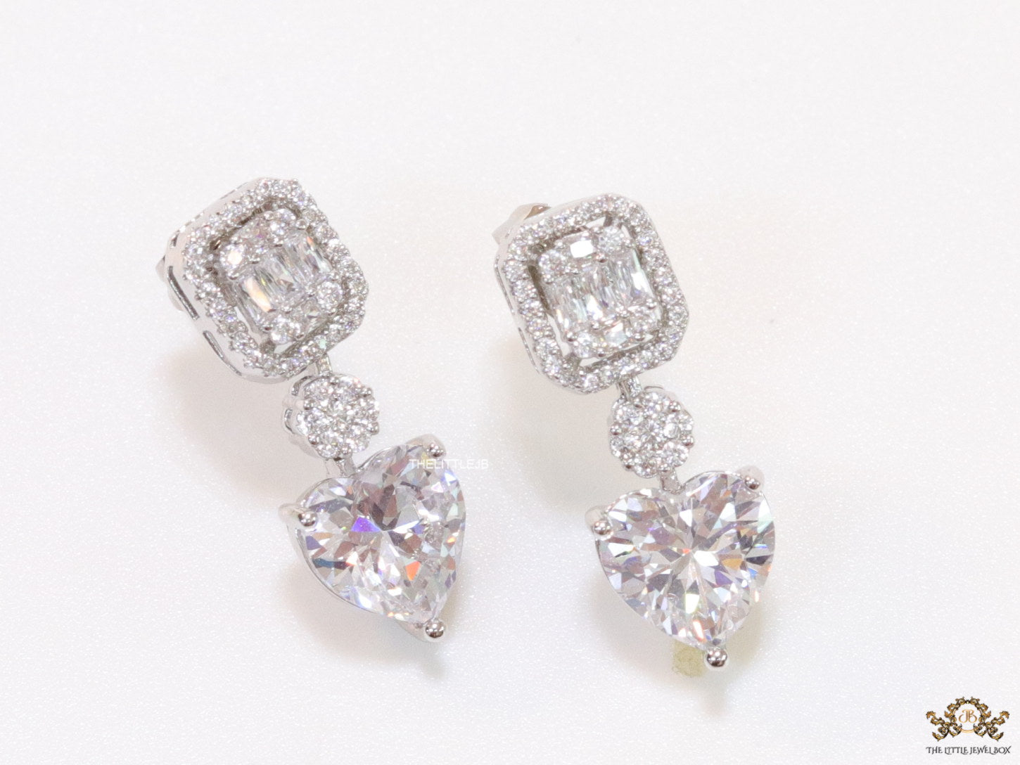 Cz baguette earrings in platinum with heart shape cz drop