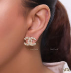 Golden twin C motif studs with fancy cut cz