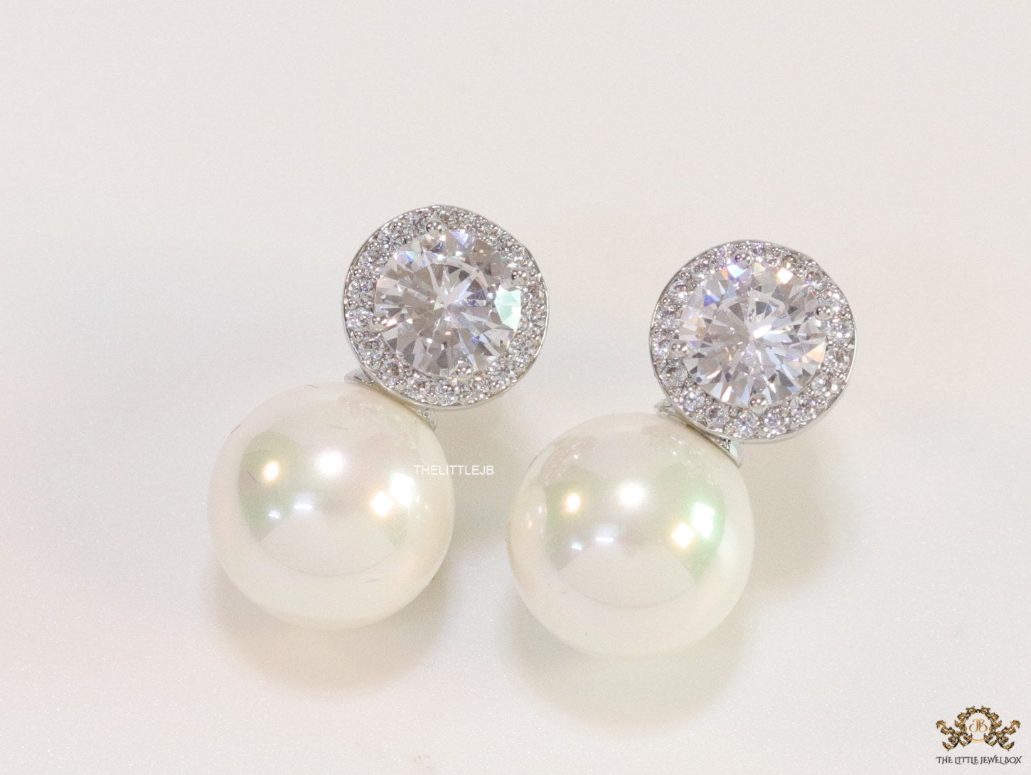 Platinum plated round cz earrings with pearl drop