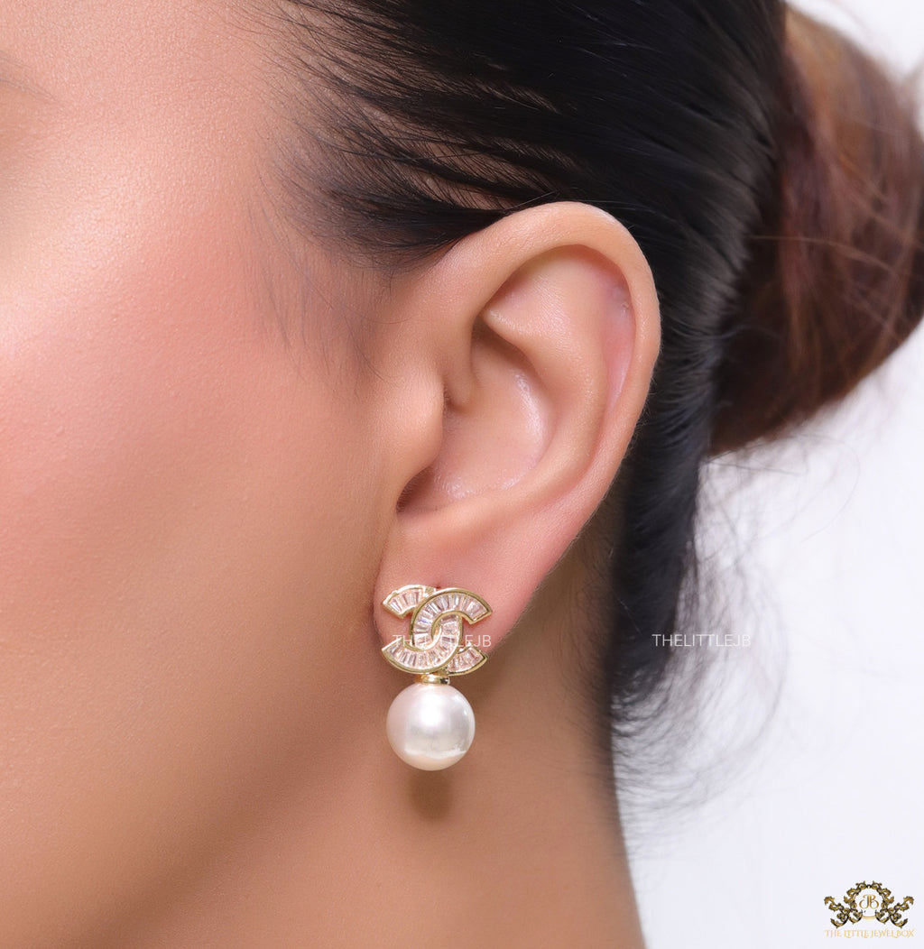 Golden cz baguettes studded twin C motif stud with pearl drop