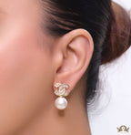 Golden cz baguettes studded twin C motif stud with pearl drop