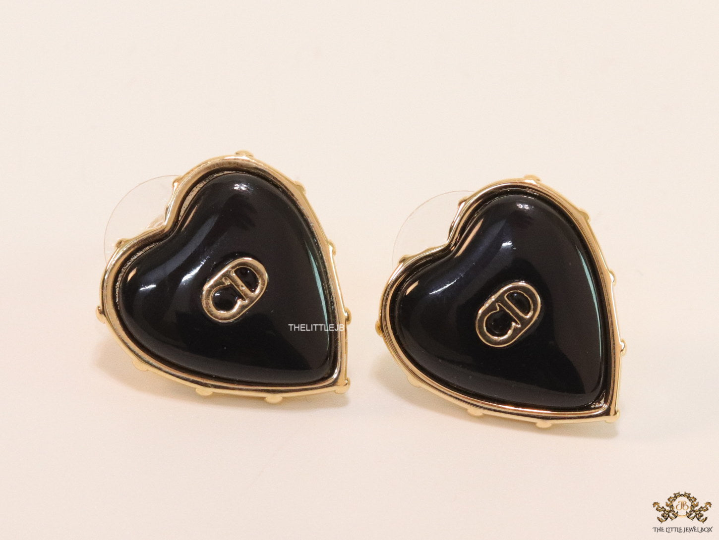 Heart shape black stud earrings with golden alphabets