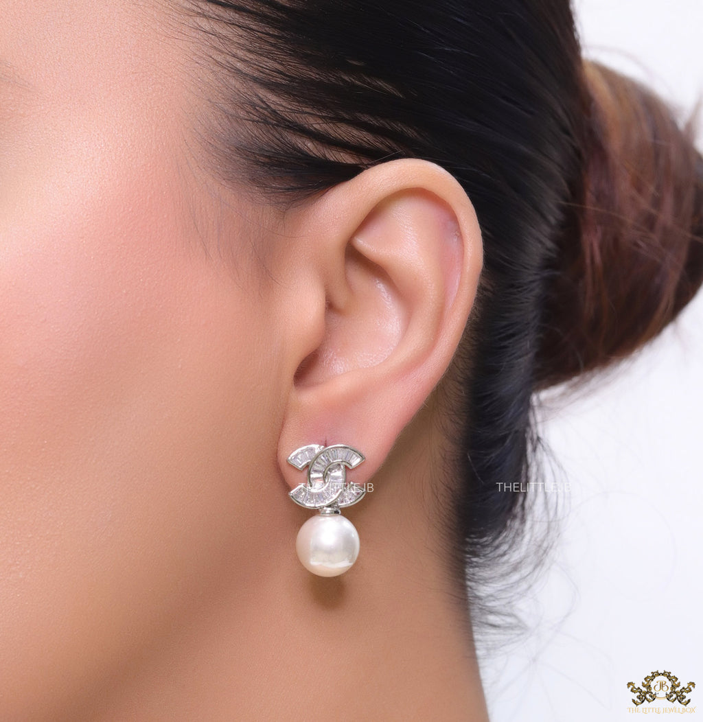 Platinum cz baguettes studded twin C motif stud with pearl drop