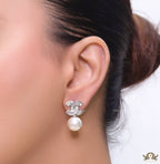 Platinum cz baguettes studded twin C motif stud with pearl drop