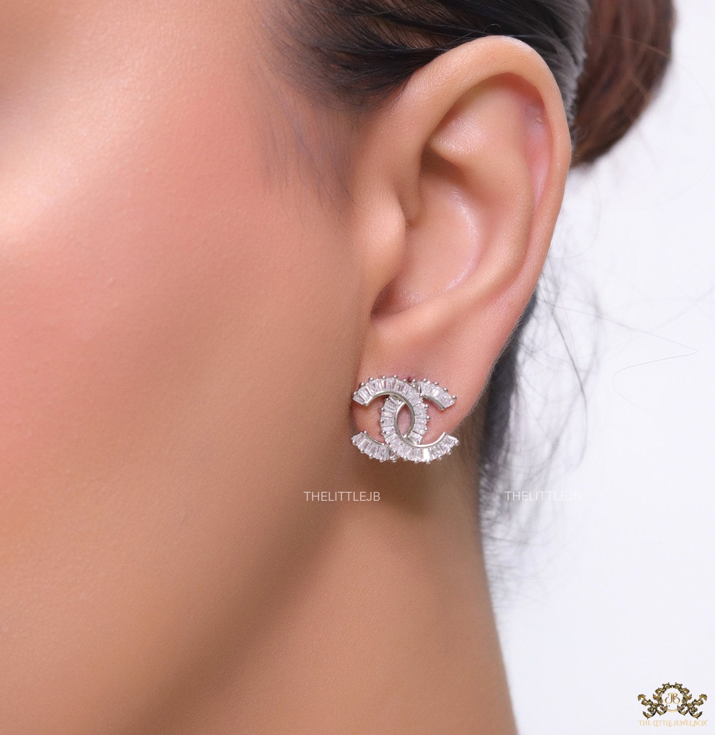 Platinum plated twin C motif studs in cz baguettes