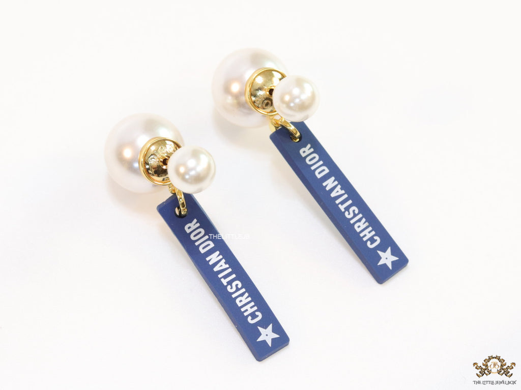 Blue silicon lapel drops with branding on pearl bomber studs