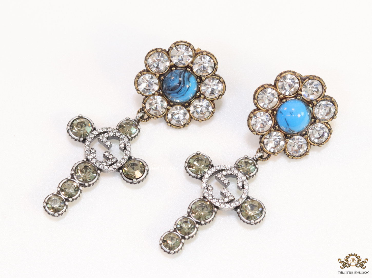 Floral cz and alphabet dangles with blue stone centre
